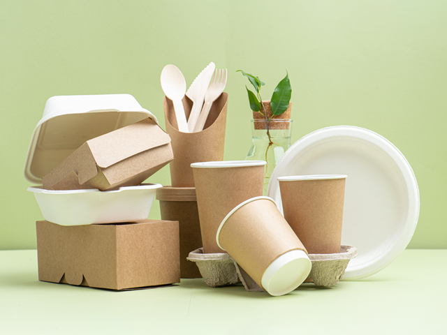 eco-friendly products on table with green background
