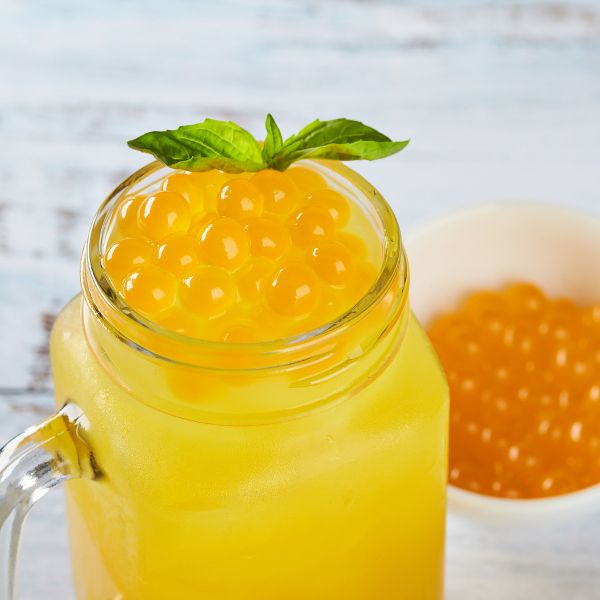 Tea Zone Passionfruit popping pearls on top of drink in a mason jar