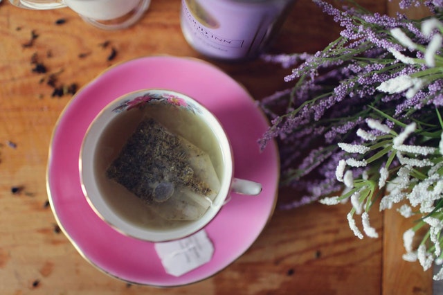 teabag in teachup and lavender flowers