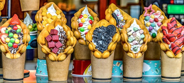 bubble waffles with ice cream and toppings on table
